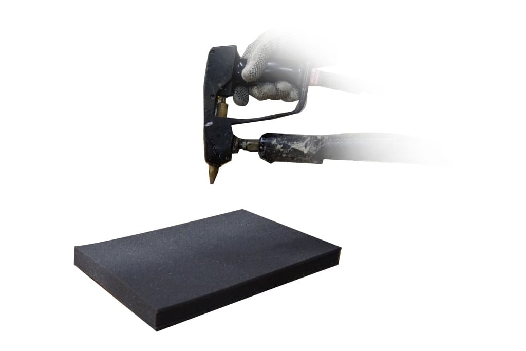 Technician using a laminating tool above a foam sheet